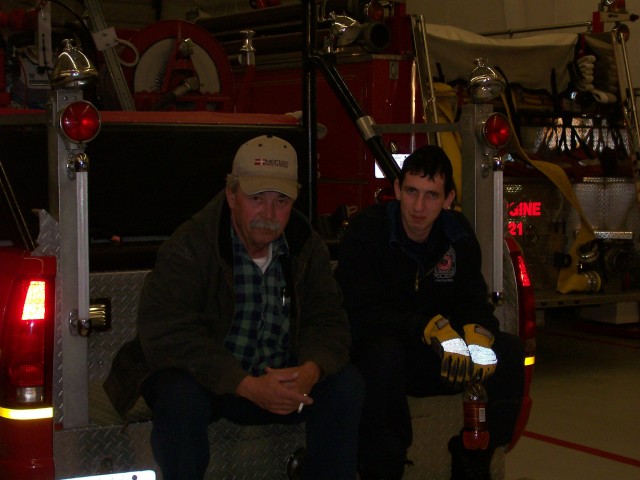 Life Member and Past President Jimmy Mattingly (Left)and Firefighter/EMT Scott Bellevou chillen on the rear of Brush 2 