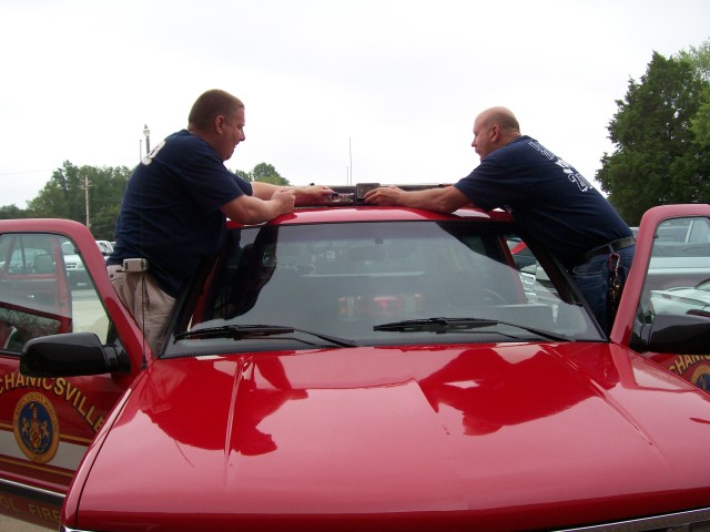 Assistant Fire Chief Raley and Captain Emmart re-install the Opticom on Command 2 