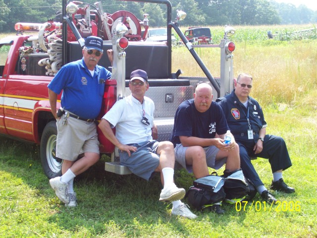 (Left to Right) Life Members Jimmy Mattingly and Harold Anderson, Lieutenant Dan Emmart and Jim Kurtz (EMS 29) chill on the Brush Truck during a burn drill  