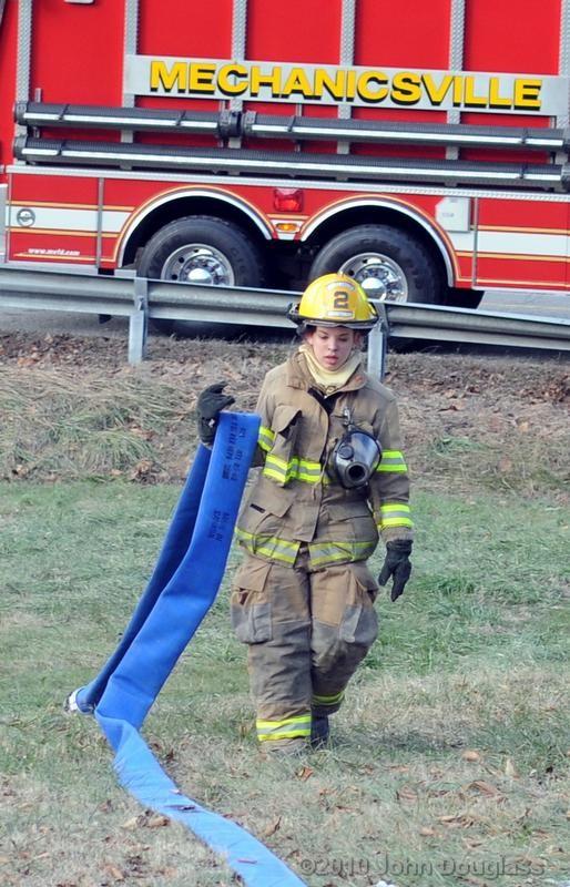 Firefighter/EMT Salina Buitron picking up the 4&quot; LDH after a house fire 