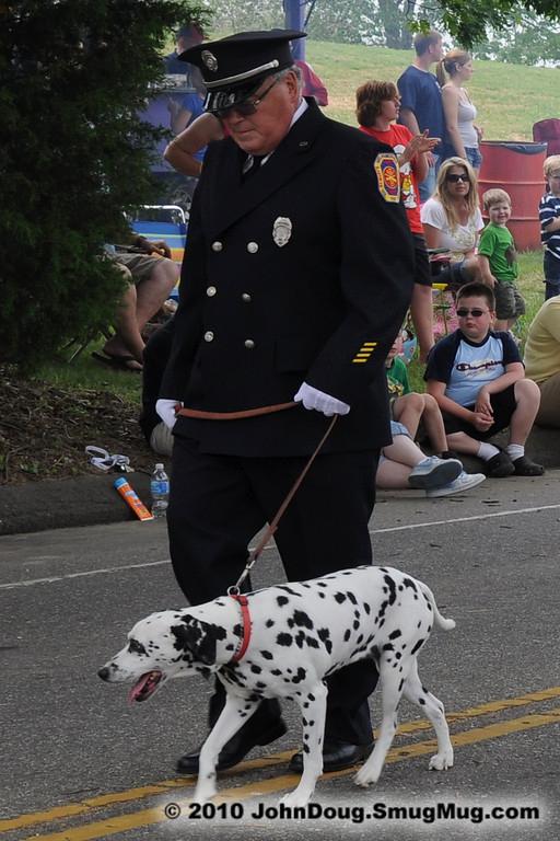 Treasurer Ferd Reetz with his Dalmation marching in the Parade