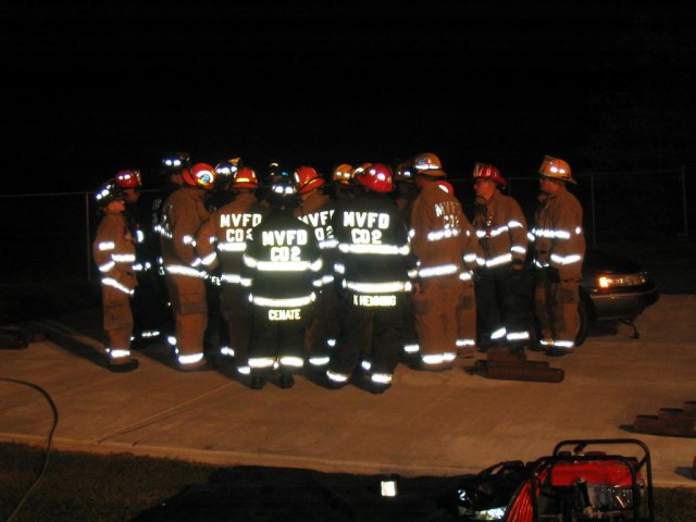 Firefighters listen to the instructor on drill night go over details on vehicle extrication