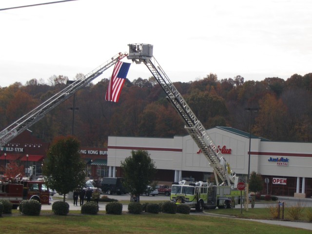 Truck-1 and Tower-13 make the arch for Life Member Paul Lacey's funeral