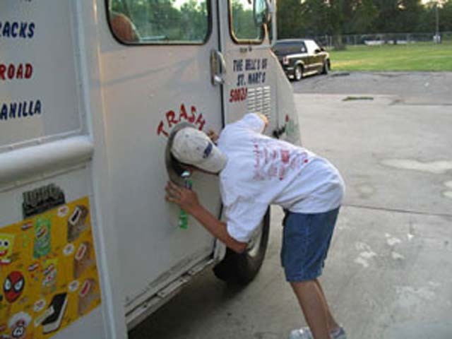 Lil Barnes plays peek-a-boo with the ice cream man.