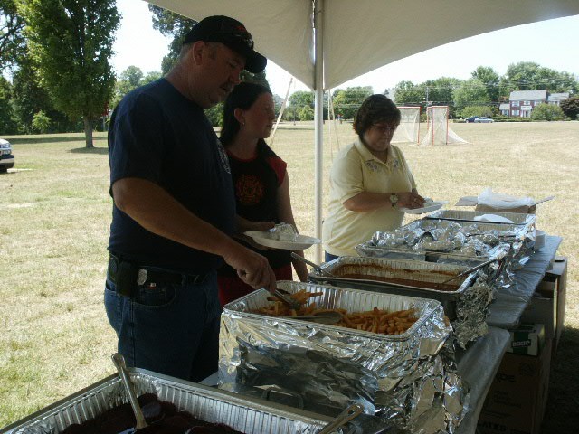 Captain Emmart making a plate of food at the Fire/Rescue Appreciation day