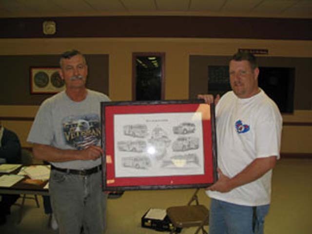 Chief Johnson presents Past Chief Raley with a hand drawn picture showing some of the major accomplishments we achieved while he was the Fire Chief.