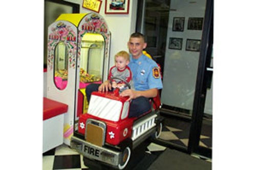 Robert takes his first ride on a fire truck.