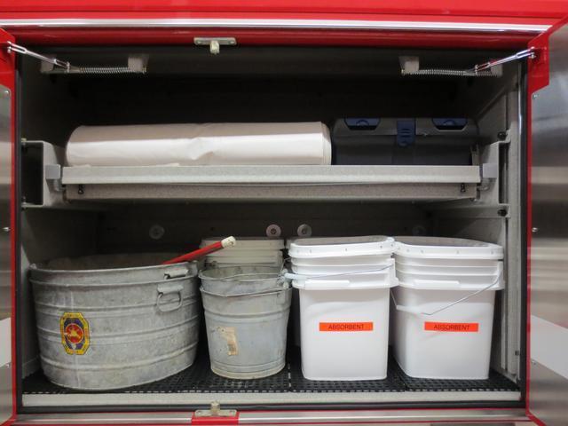 Drivers side compartment (D3) houses five absorbent containers, salvage buckets, carpet runner with tool kit