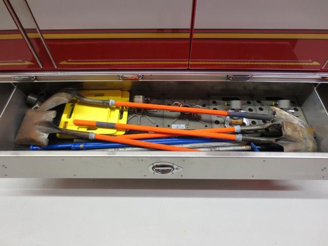 Officers side under body compartment houses long handled shovels, long pickets and base plates for the Paratech Struts and Res Q jacks