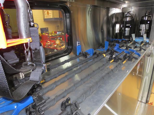 Walk in section containing additional hooks, halligan bars, flashlights and two water cans