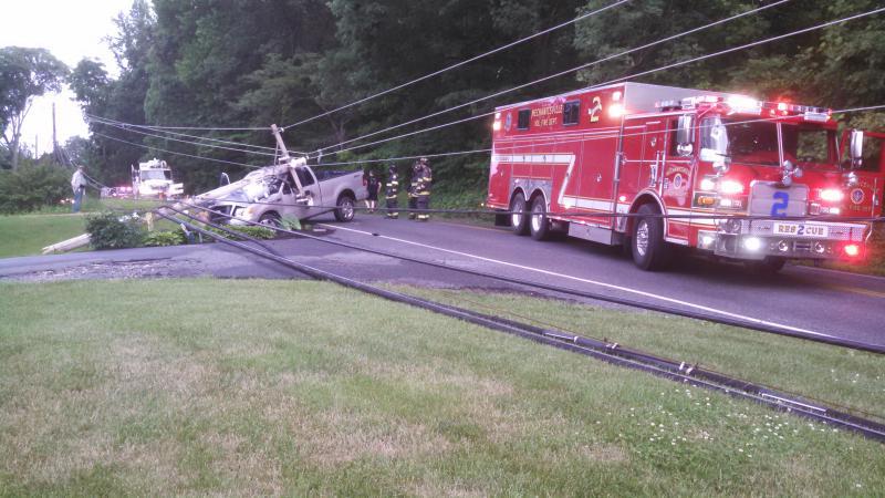 Squad 2 operating on the scene of a vehicle into a pole.