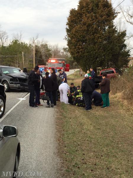 Firefighters tend to one of the injured after two vehicles collided on Mechanicsville Road. 