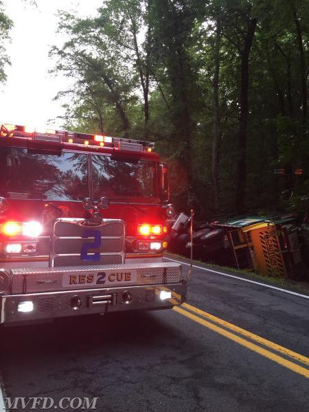 The rescue on scene of an overturned refuse truck on Chaptico Road.