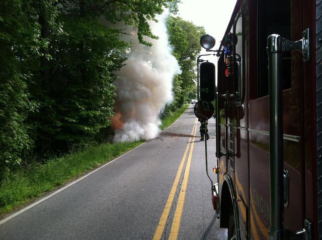 Engine 21 operating on the scene of a vehicle fire as a result of crashing into a tree